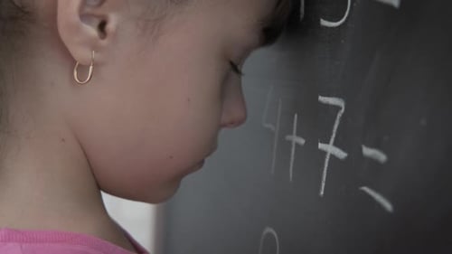 Close Up of Girl Doing Math at School