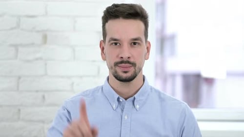 Man Expresses Disagreement by Shaking Head and Pointing