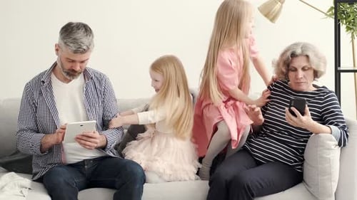 Family Relaxing with Technology on the Couch