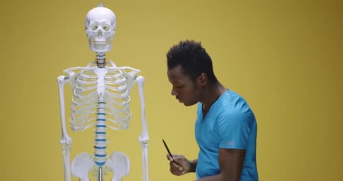 Young Adult Explains Human Skeleton Model