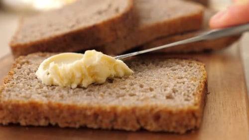 Spreading Soft Butter on Brown Bread Slice