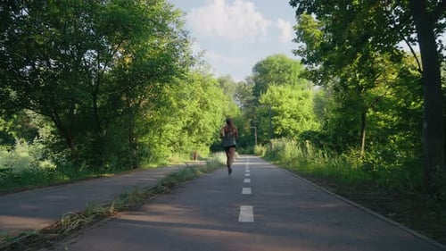 Woman Jogging in Summer Park in Slow Motion