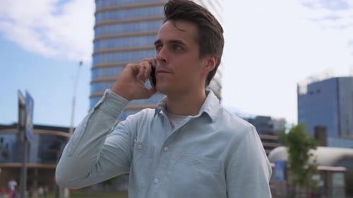 Man Talking on Mobile Phone in Urban Setting