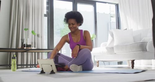 Woman Exercising at Home with Tablet