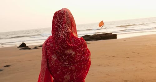 Young Women Wearing a Red Saree on the Beach Goa India