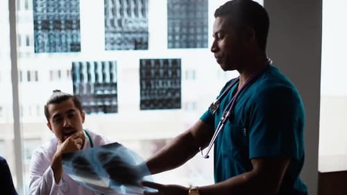 Medical Professionals Reviewing X-Ray in Hospital Office