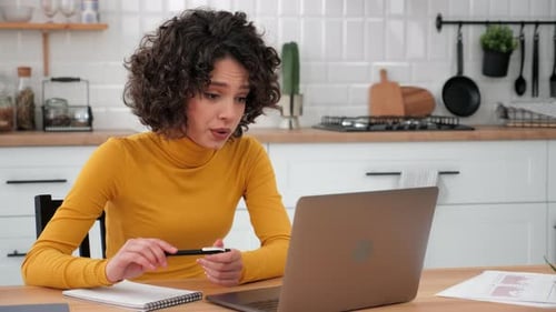 Woman Using Laptop for Video Call in Kitchen