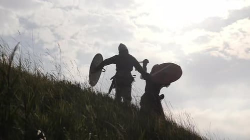 Silhouetted Warriors in Sword and Shield Hilltop Battle