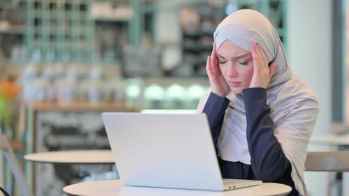 Woman in Hijab Working on Laptop, Headache