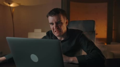 An Angry Hater Starts to Smoke Looking at the Laptop Screen