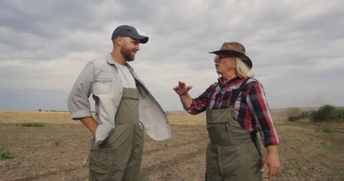 Farmers Talking During Plough in Field
