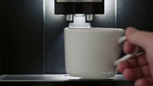Close Up of Mug Placed Under Coffee Machine