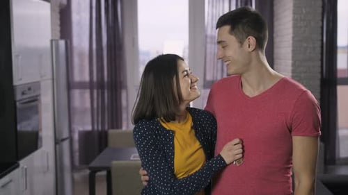 Happy Couple Holding Keys in New Apartment