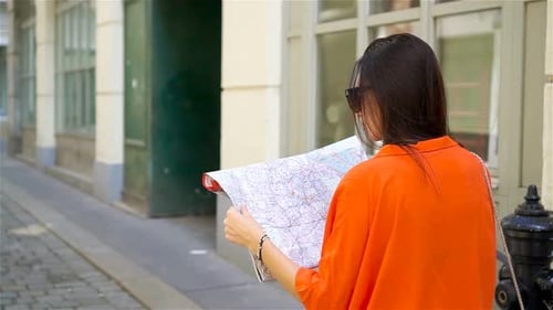 Young Woman with a City Map in City. Travel Tourist Girl with Map in Vienna Outdoors During Holidays