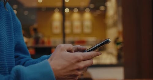 Side View on Young Woman Hands Using Smartphone