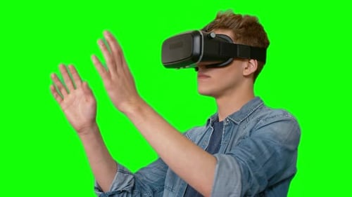 Young Adult Wearing VR Headset on Green Screen