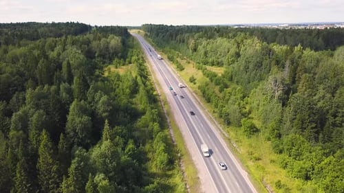 Aerial View Of Car Driving Through The Forest On Country Road