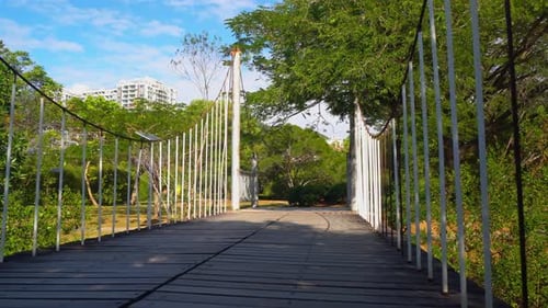 Low Angle View Walking Across Suspension Bridge