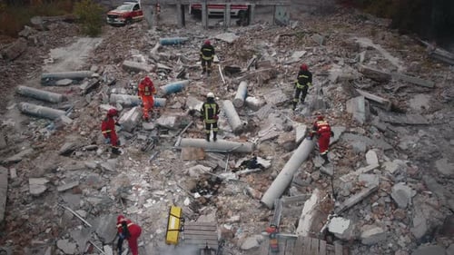 Emergency Service Workers Examining Ruins
