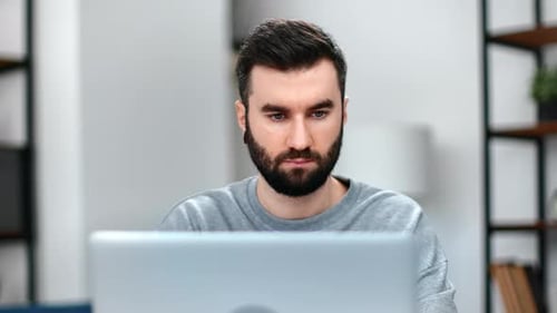 Bearded Man Using Laptop Computer Indoors