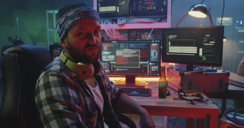 Man Coding at Computer Station in Office