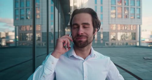 Smiling Man Talking on Cell Phone Outside Office