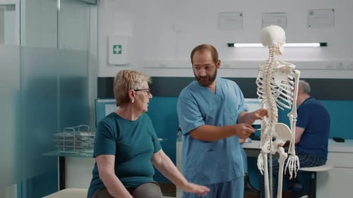 Osteopath Explaining Orthopedic Diagnosis on Human Skeleton