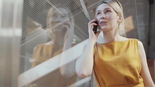 Woman Talking on Cell Phone in Urban Setting