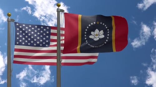 United States and Mississippi State Flags Waving on Flagpoles