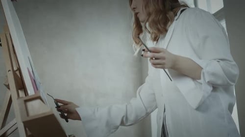 Young Woman Painting at Home with Palette Knife