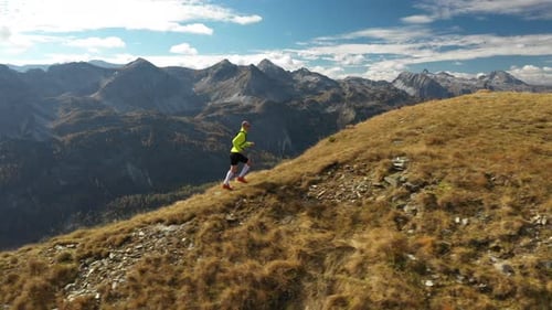 Aerial View Man Trail Running on Ridge in Mountains