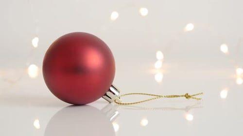 Close-up of round Christmas decoration slow tilt 4K 2160p 30fps UltraHD footage - Red shiny bauble