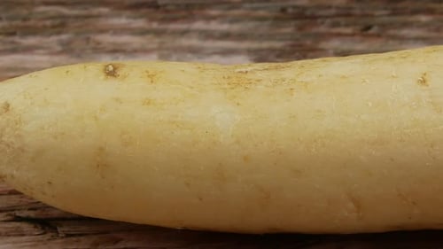 Fresh Daikon Radish Rotating on Wooden Surface