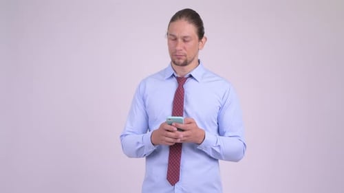 Thoughtful Man Using a Smartphone in the Office