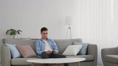 Young Adult Playing Video Games at Home