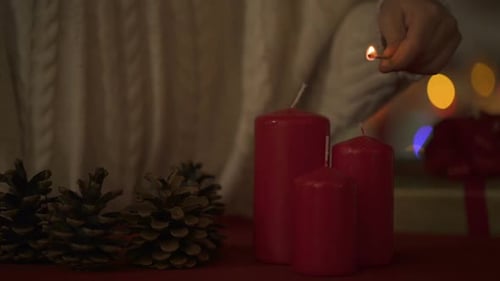 Lighting Candles for Christmas with Pine Cones