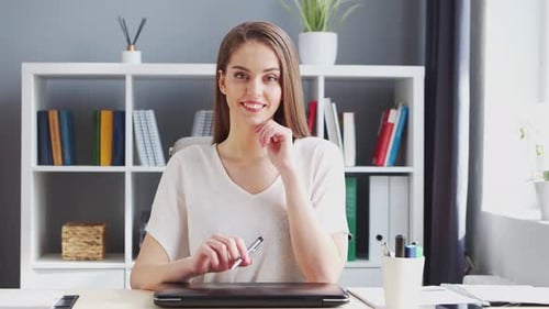 Young Woman Works at Home Office Using Computer.