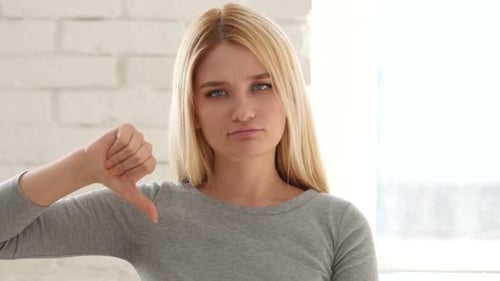 Blonde Woman Thumbs Down Close Up