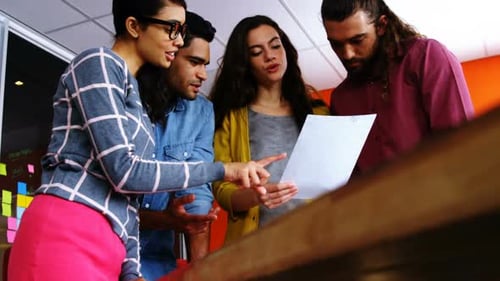 Team Collaborating on Project in Creative Office