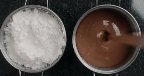 Chocolate Being Poured Next to Pot of Powder