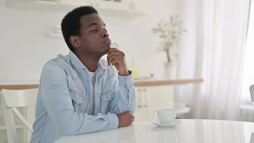 Pensive African Man Thinking at Home