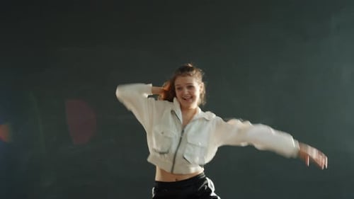 Young Woman Dances Energetically in Studio