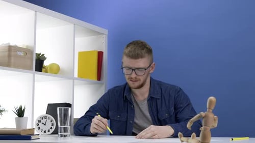 Concentrated Male Engineer or Architect Working on Layout, Creative Workplace