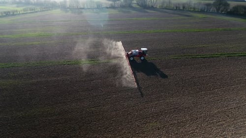 Tractor Spraying Fields on an Arable Farm with Glyphosate Herbicide