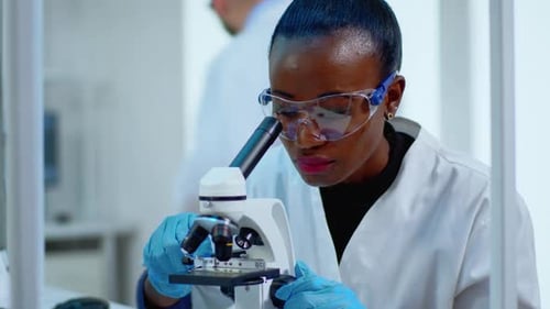 Close Up of Black Woman Looking in Microscope