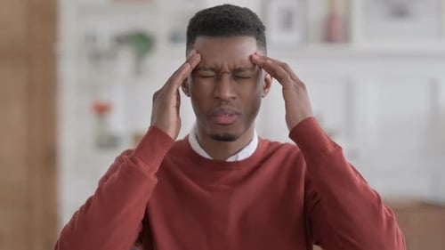 Young Adult Massaging Temples with a Headache