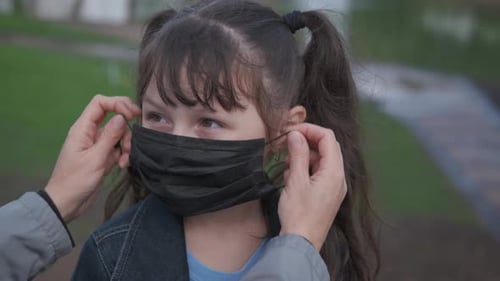 Child Gets Mask Adjusted on Face