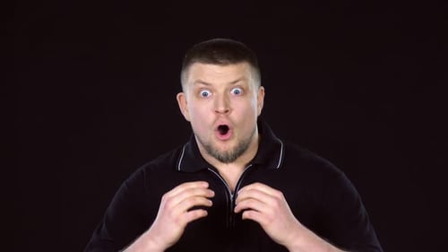 Man Expressing Shock and Surprise on Black Background