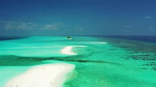 Daytime aerial tourism shot of a white sand paradise beach and blue sea background in colorful 4K