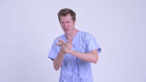 Aggressive Man in Patient Gown Jabbing Fists